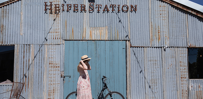 Woman arriving on bike to Heifer Station Wines in Orange